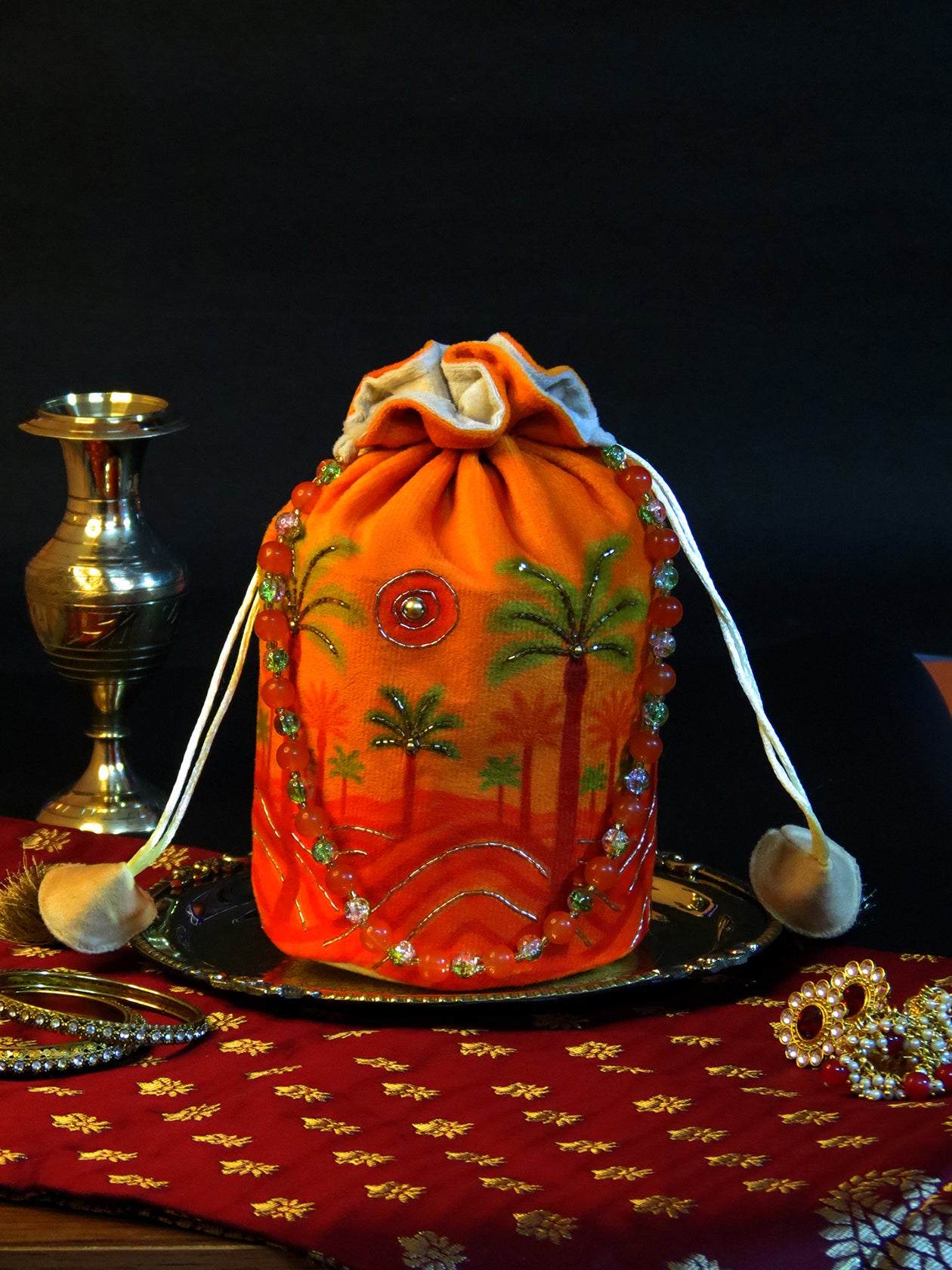 Bright Orange Velvet Potli Bag with Scenic Palm & Sun Motif